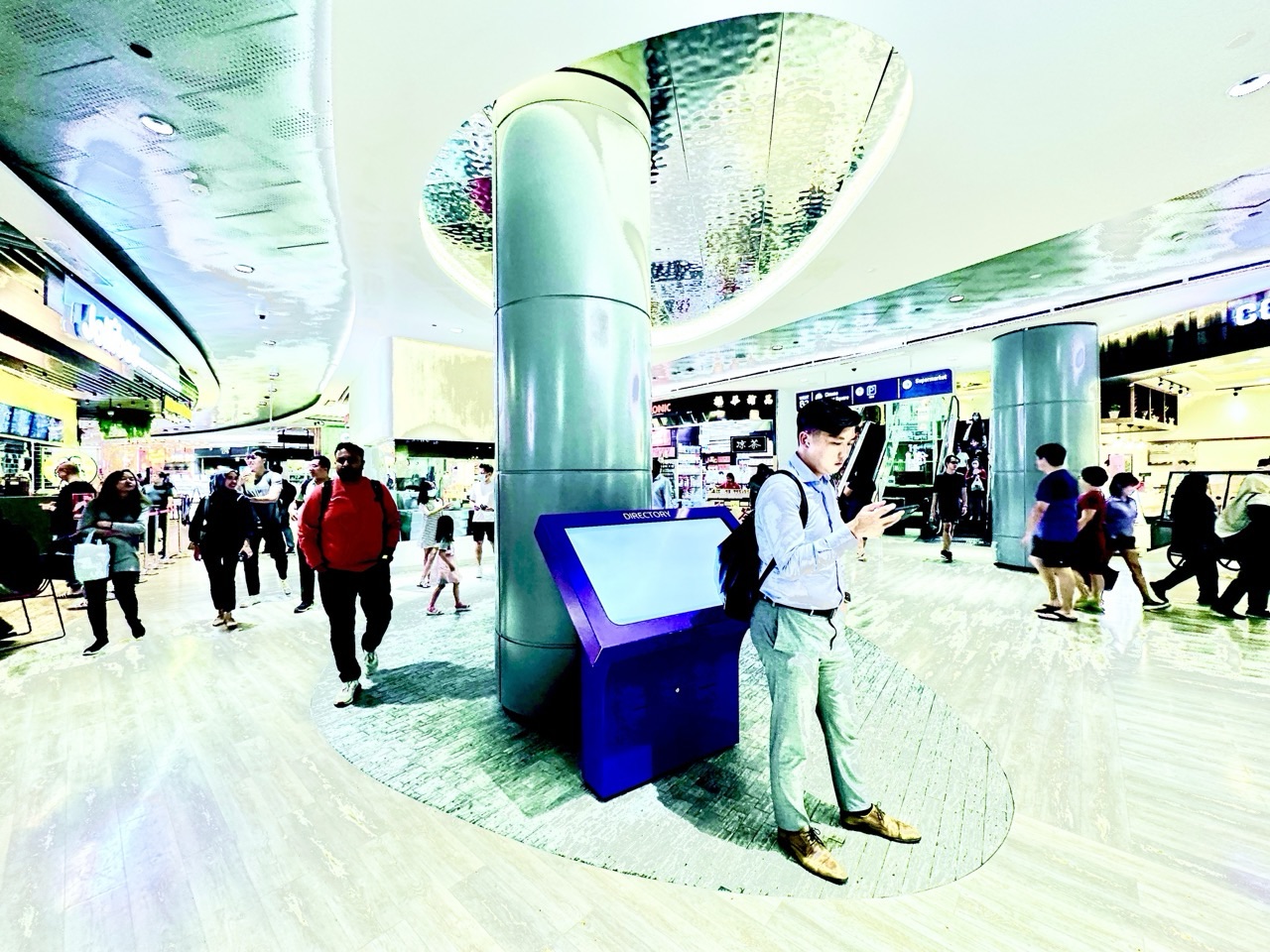 Shoppers inside Waterway Point, including a person looking at a phone.