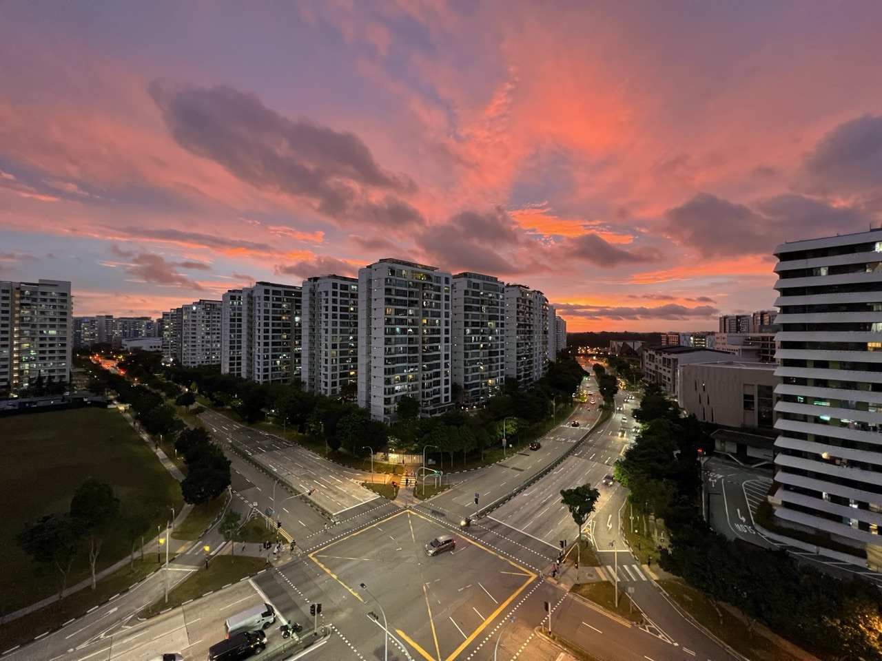 Sunset over Punggol Central with condominium buildings and road in view.