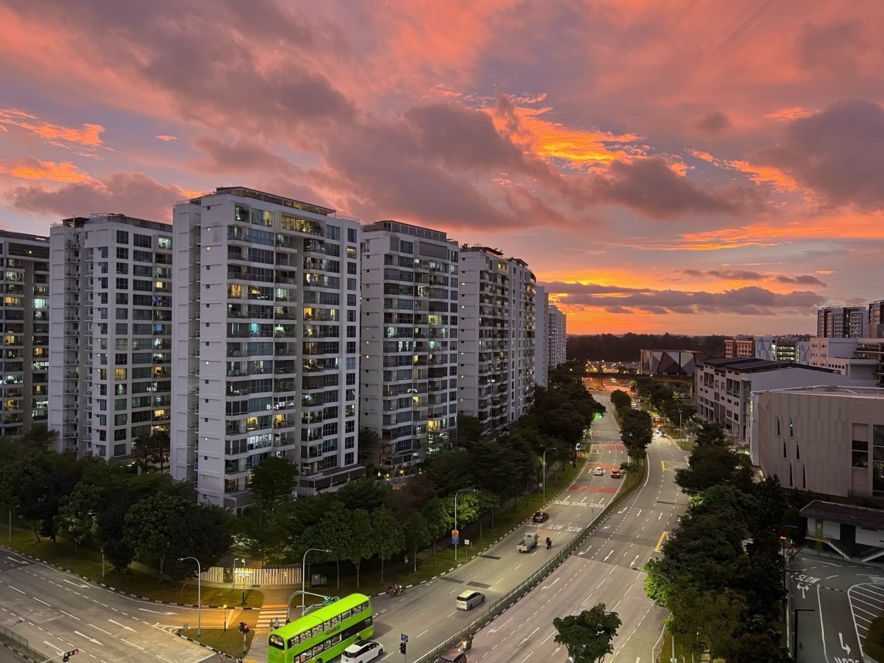 Spectacular sunset over Punggol Central with condominium buildings and road traffic.