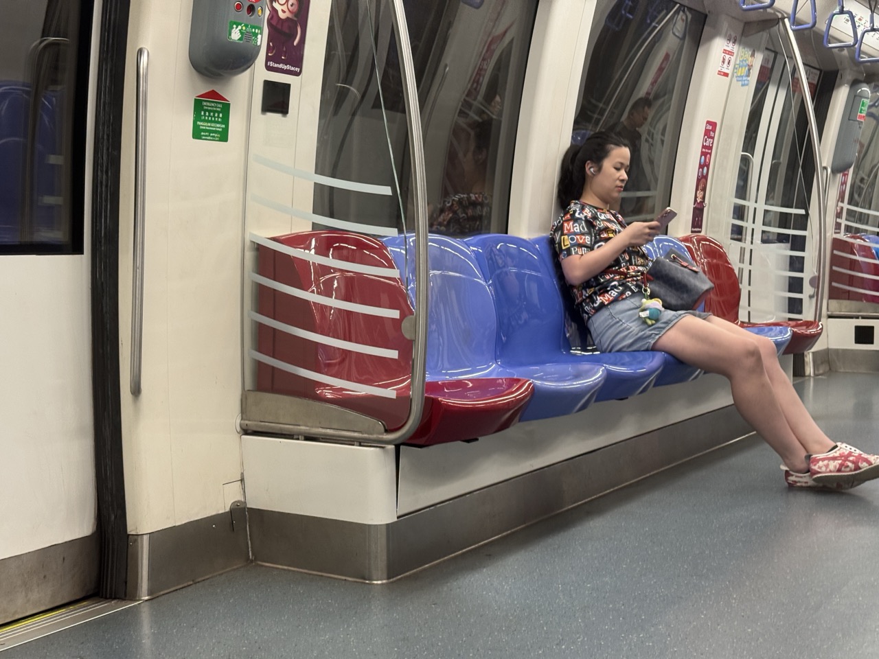 Young passenger seated inside an MRT train in Singapore.