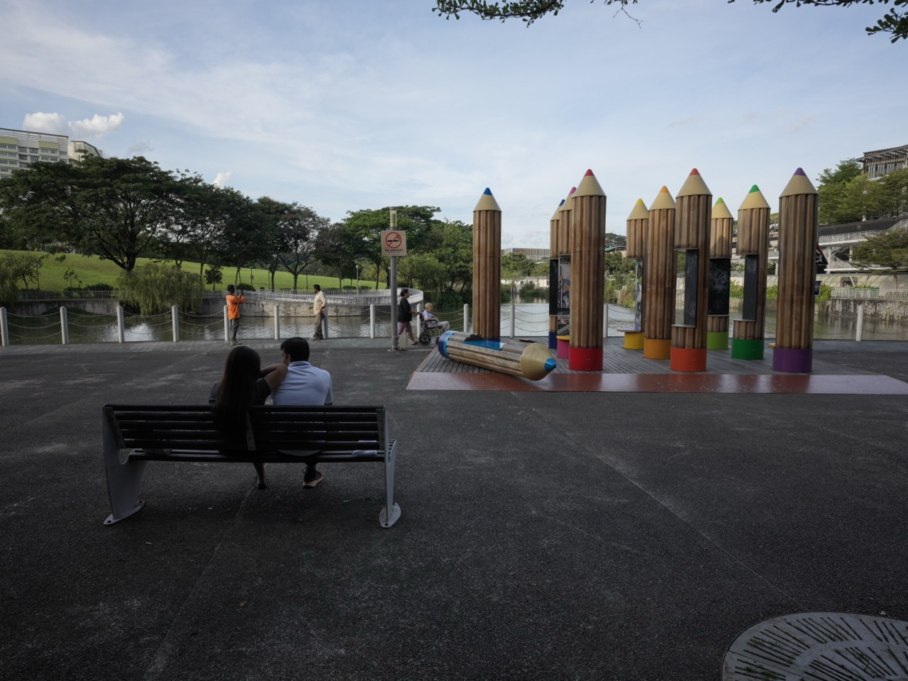 Canal, children's playground and seating at Punggol Waterway Park beside Waterway Point