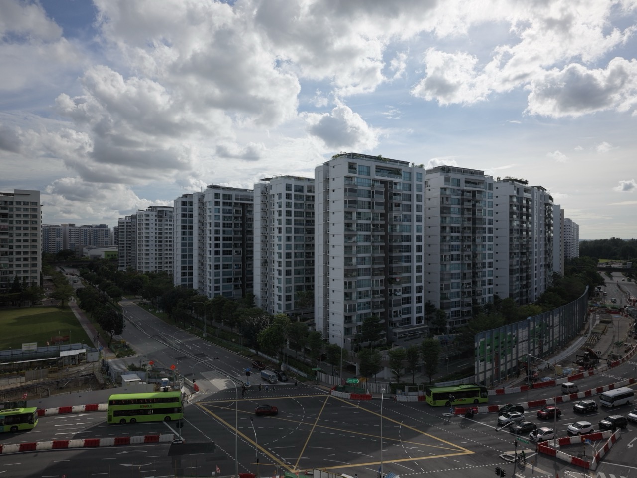 Punggol condominium beside a road, cars and construction works