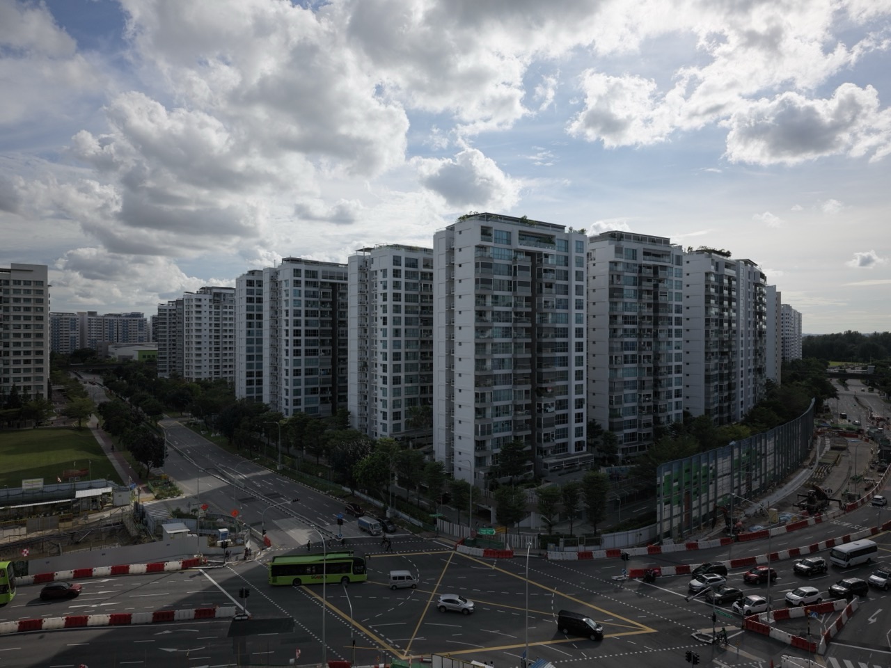 Punggol condominium and HDB flats beside a road and construction works