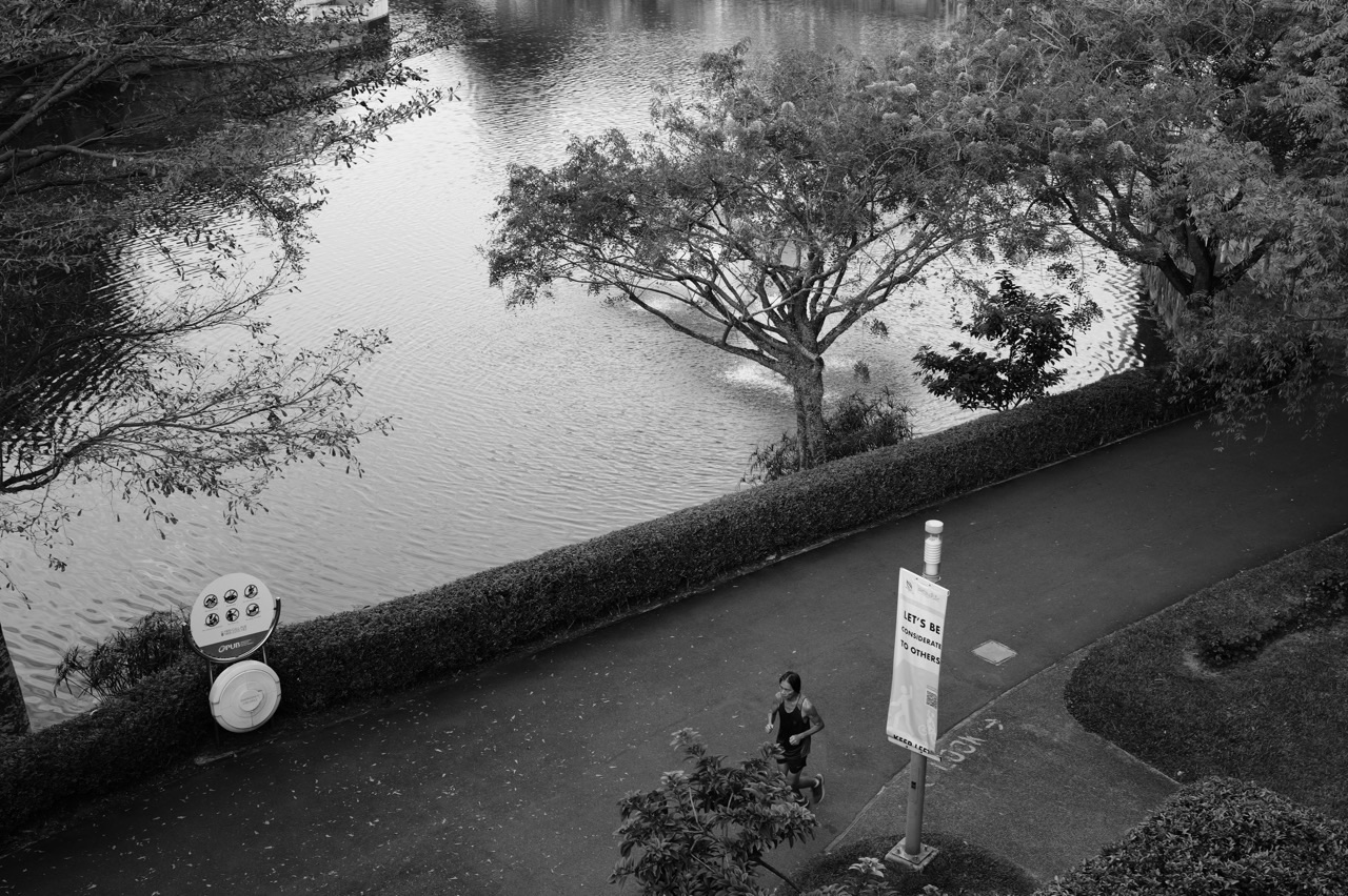 Seating and rest area at Punggol Waterway Park with a runner in the foreground