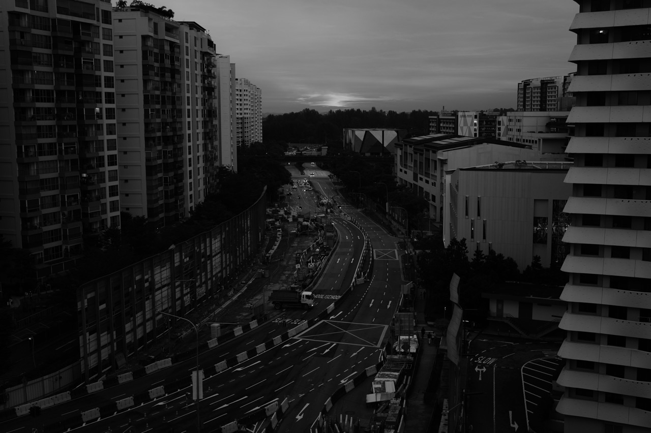 Watertown, nearby HDB flats and road construction at sunset in Punggol