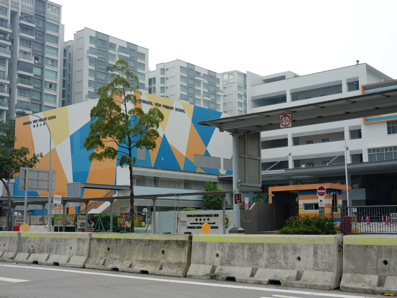 Entrance and school building at Punggol View Primary School beside HDB housing in Punggol, Singapore.