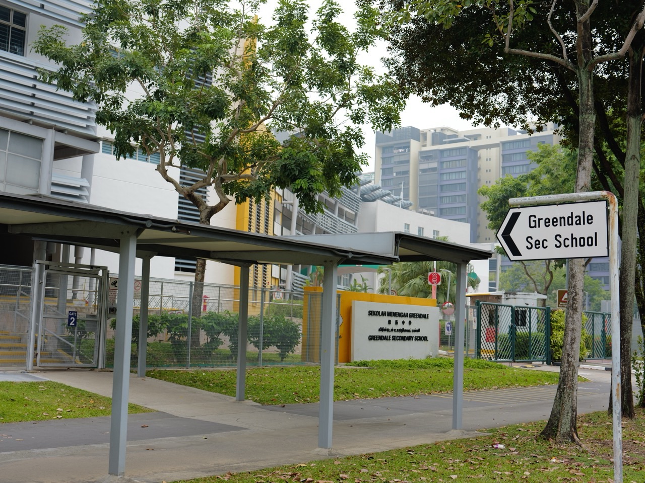 Main entrance gates, security point and school building at Greendale Secondary School in Punggol, Singapore.