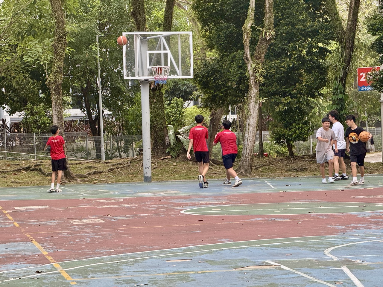People playing basketball at the court beside Playground 295 in Punggol.