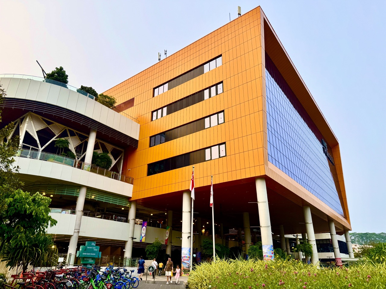 Distinctive yellow facade and entrance to One Punggol community hub.