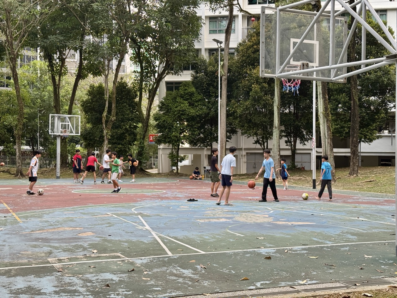 People playing basketball at a neighbourhood court beside Playground 295 in Punggol.
