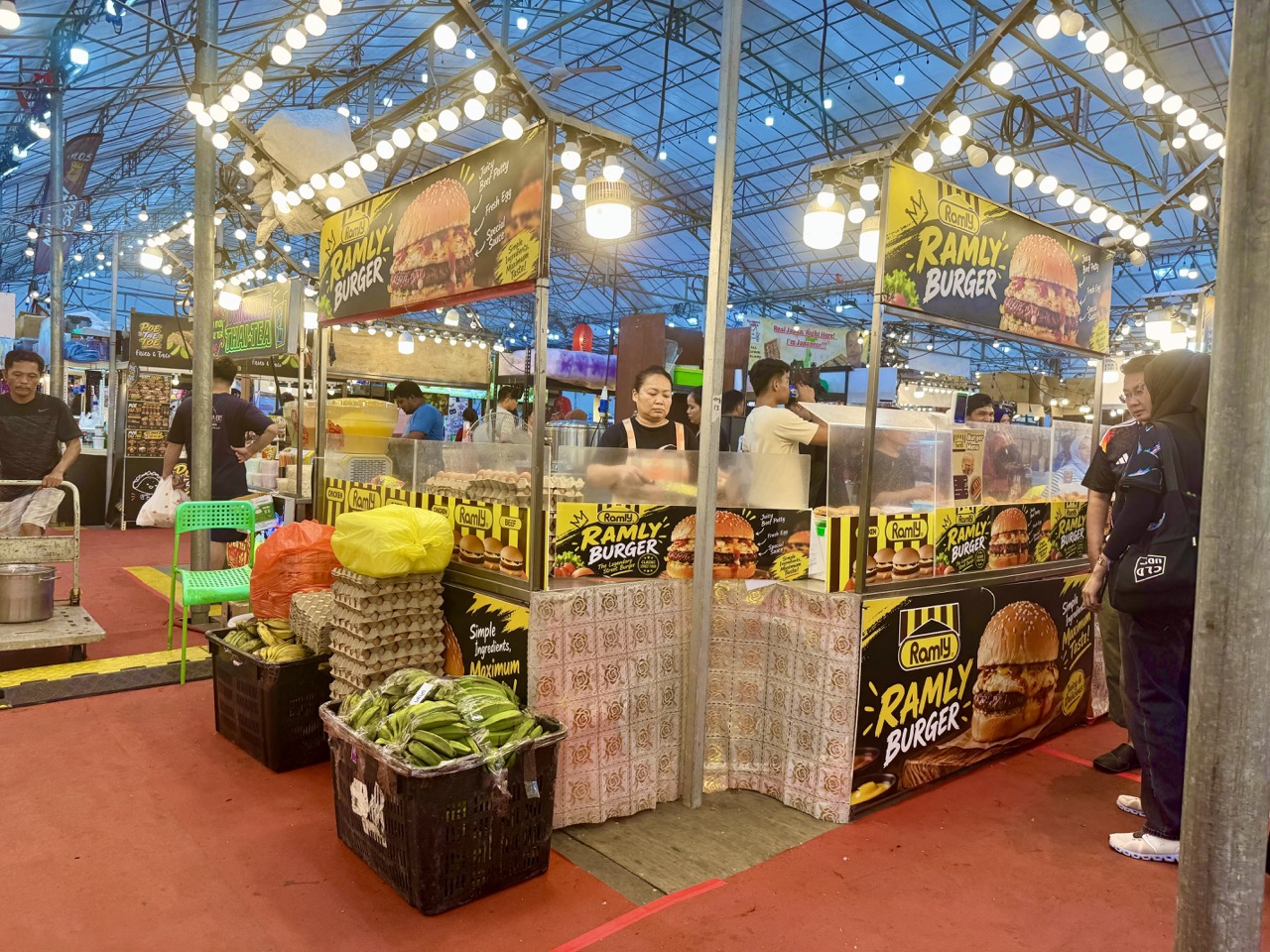 Customers visiting a Ramly burger stall at a Punggol night market.