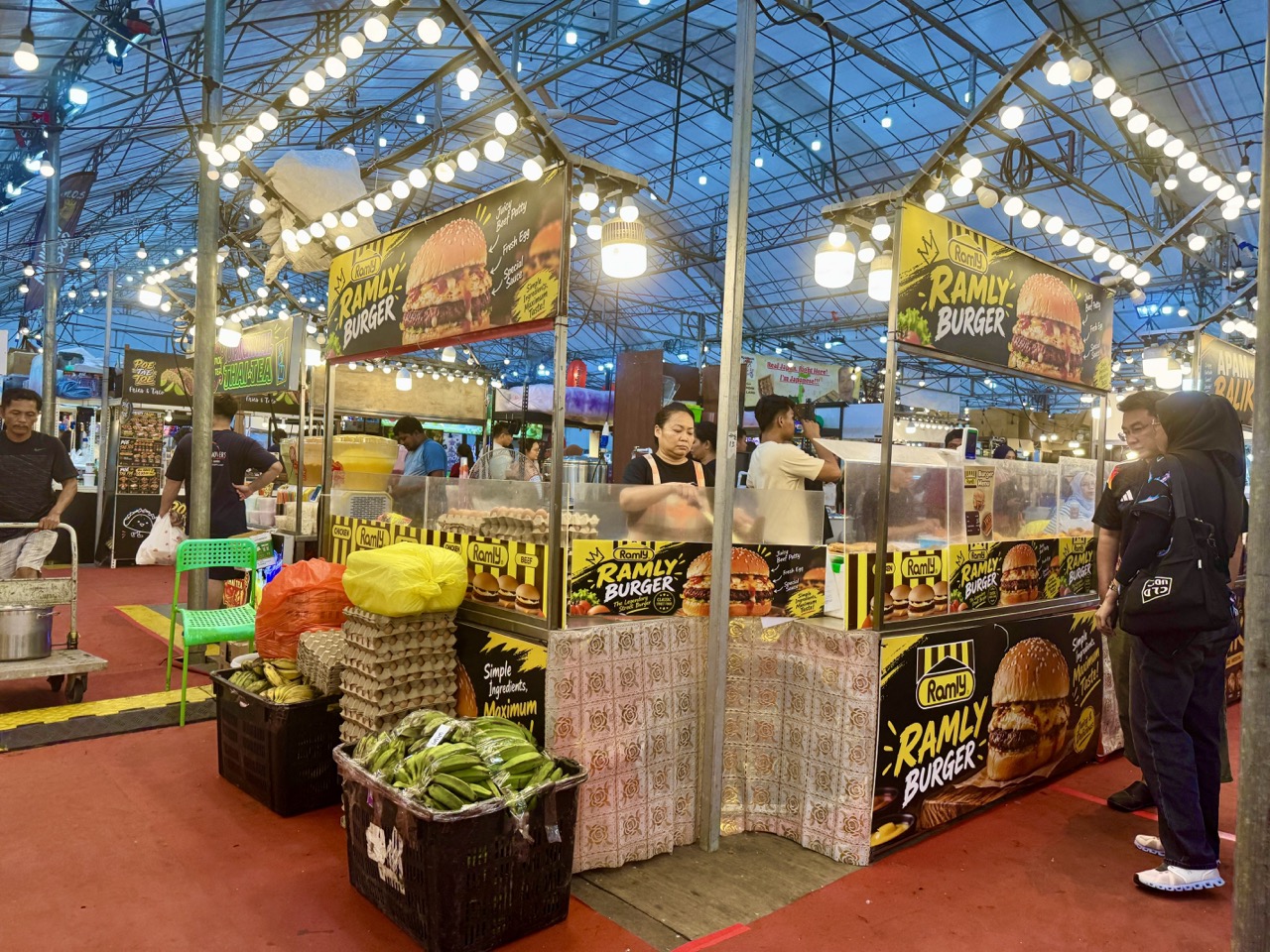 Ramly burger food stall with vendors and customers at a pasar malam in Punggol.